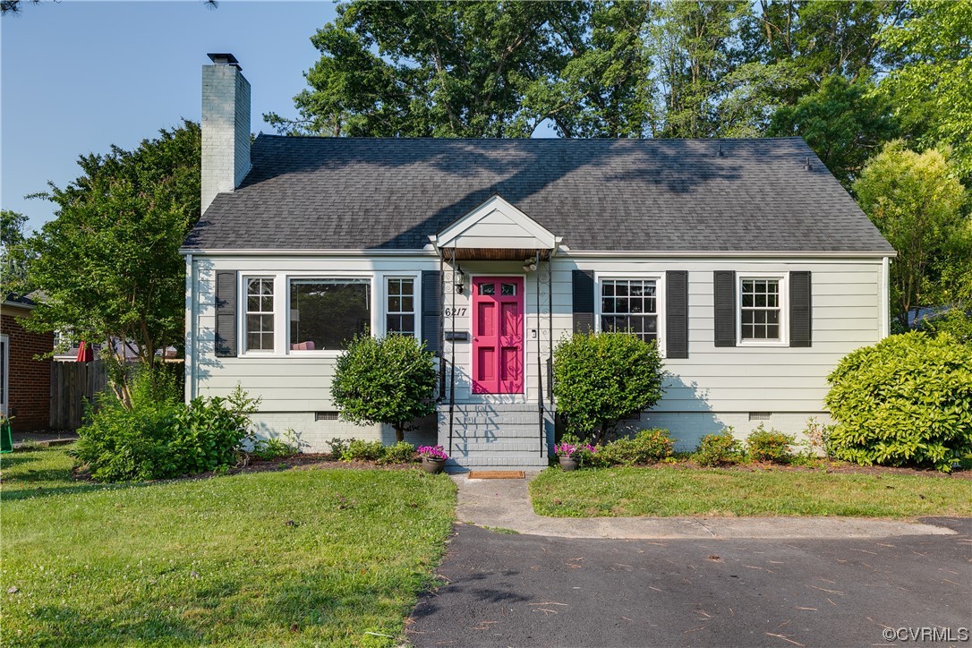 a front view of house with yard and green space