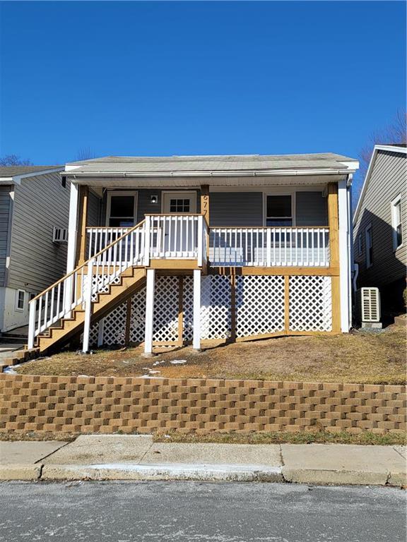 a front view of a house with a parking space