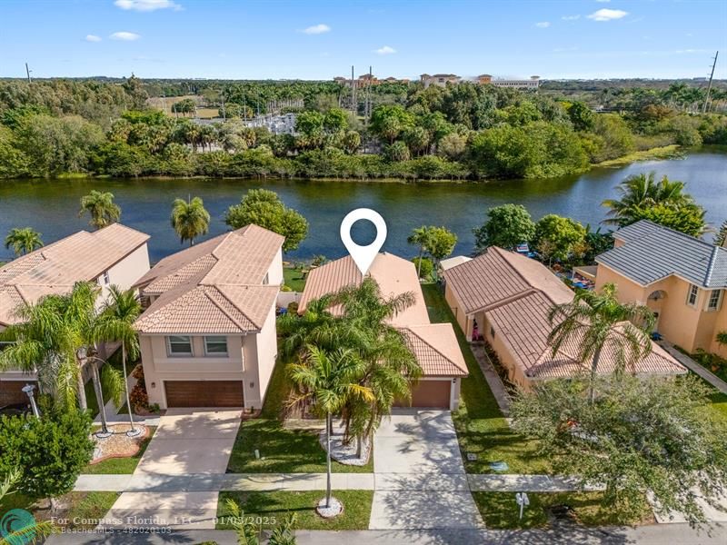 an aerial view of a house with a lake view