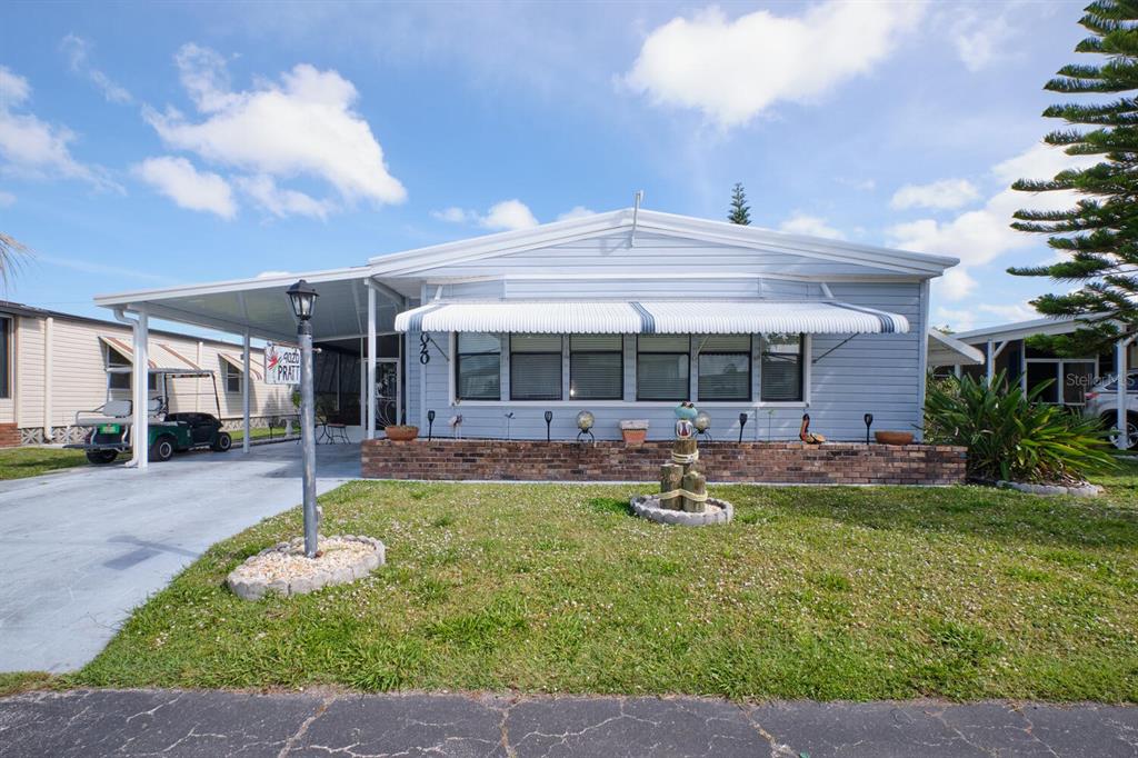 a front view of a house with a yard patio and swimming pool