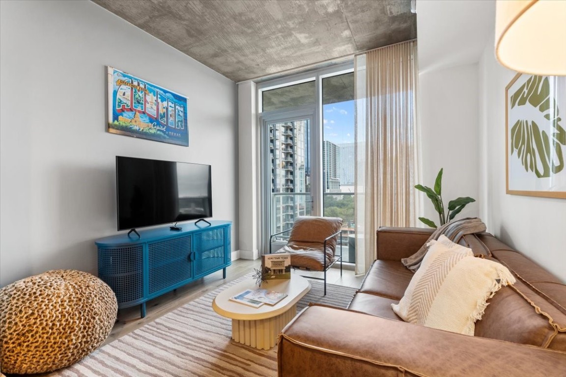 a living room with furniture and a flat screen tv