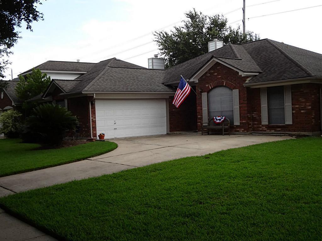 a front view of house with a garden