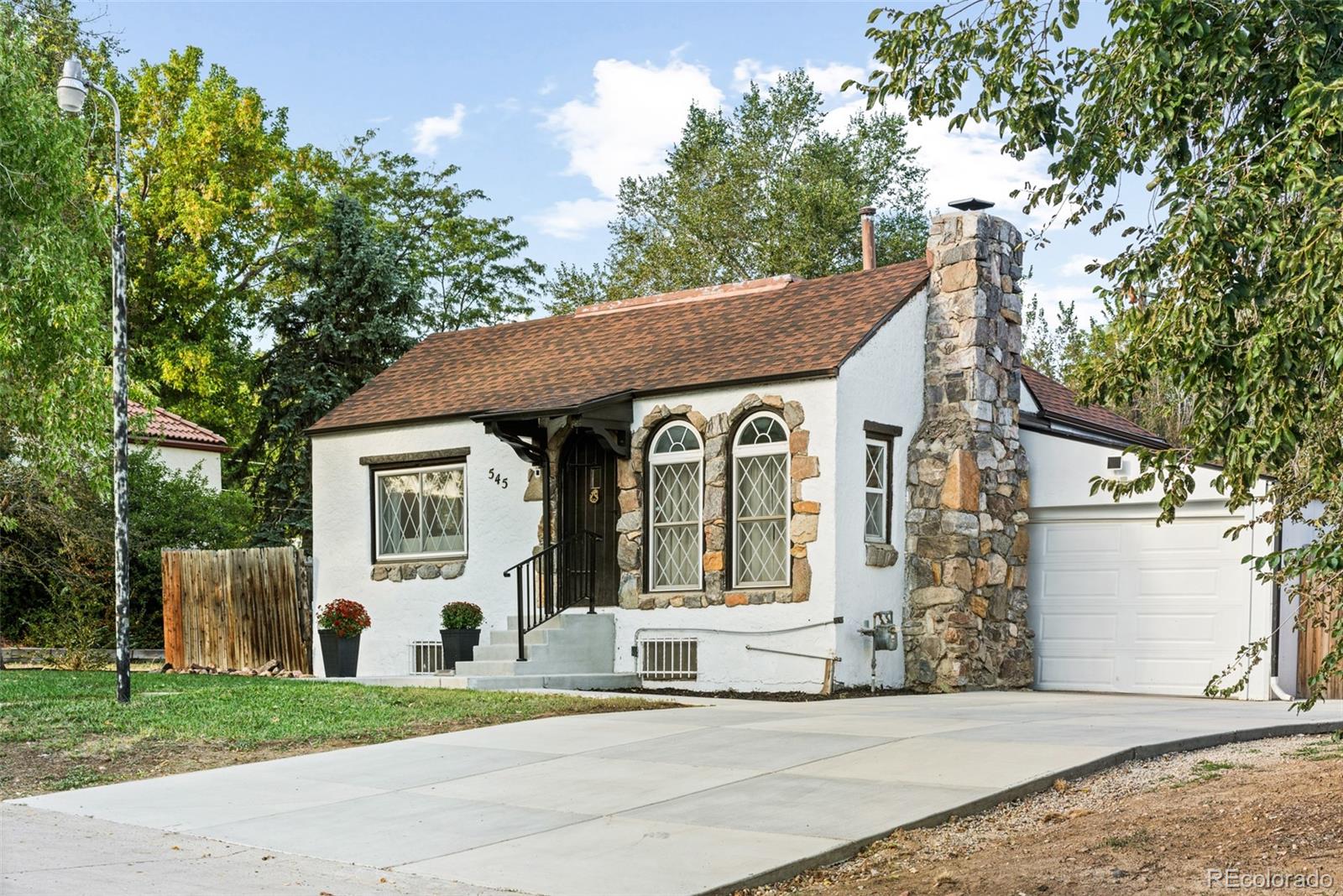 a front view of a house with a garden