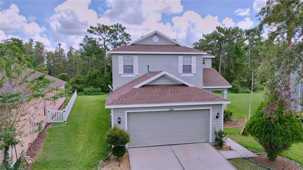 a front view of a house with a yard and garage