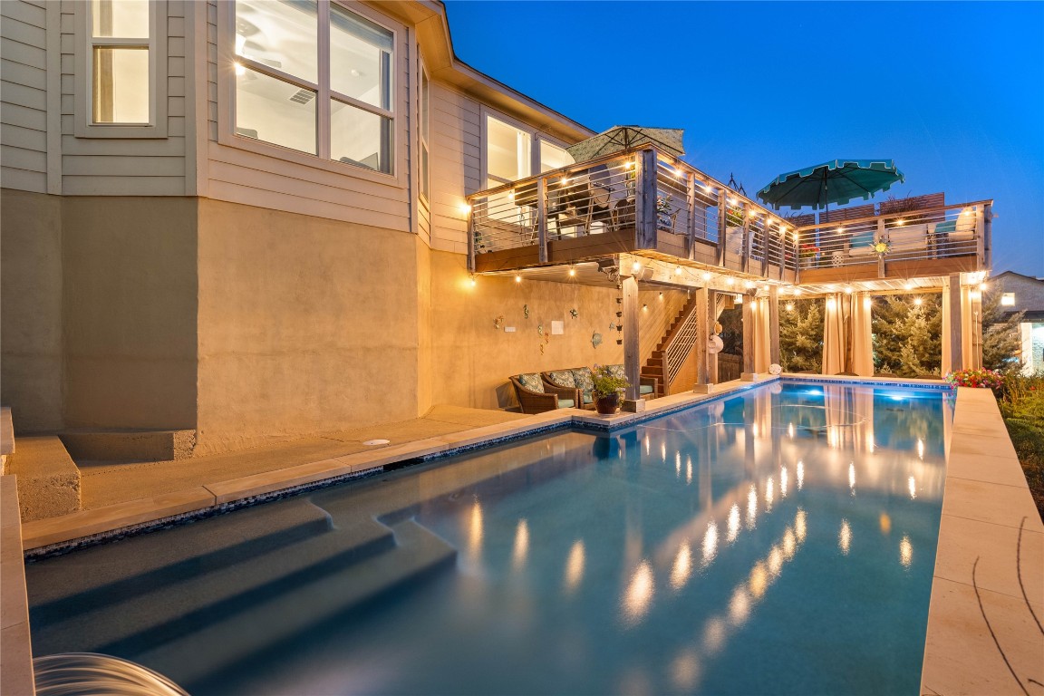 Solar-heated 40-foot pool with two-tiered modern Trex decking. Perfect for evening gatherings or unwinding outdoors.