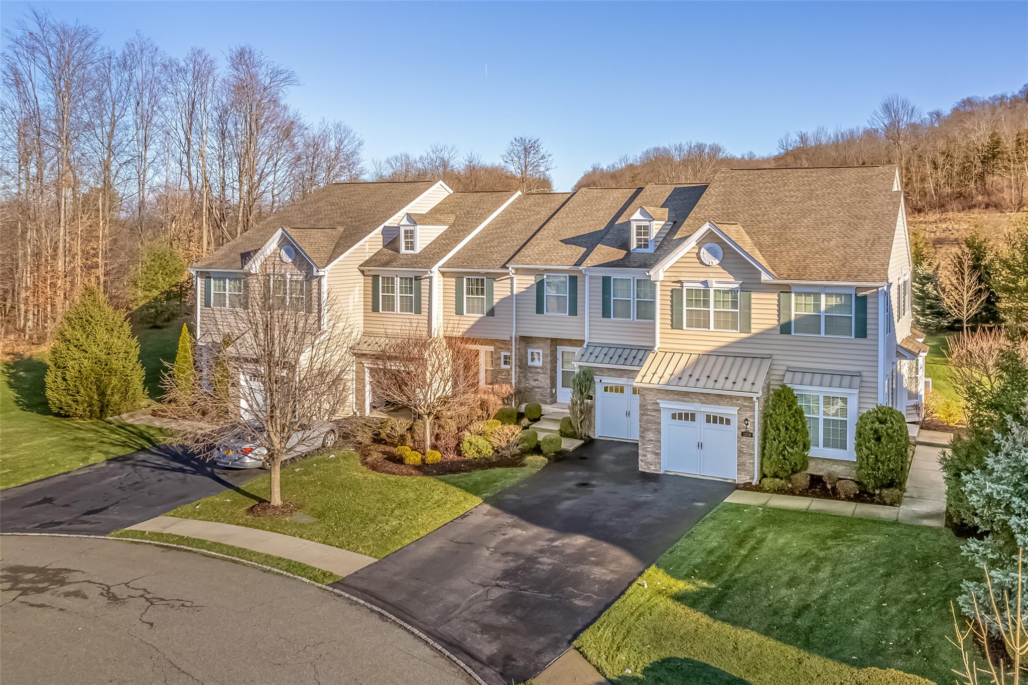 a view of a big house with a big yard and large trees