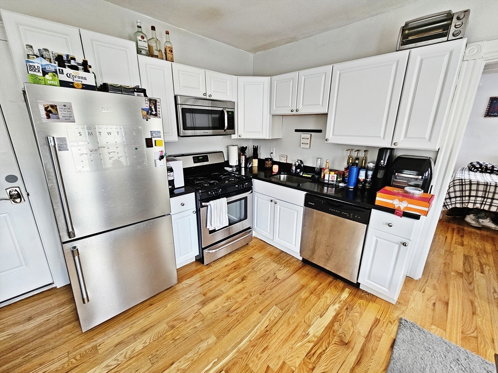 a kitchen with stainless steel appliances a refrigerator sink and microwave