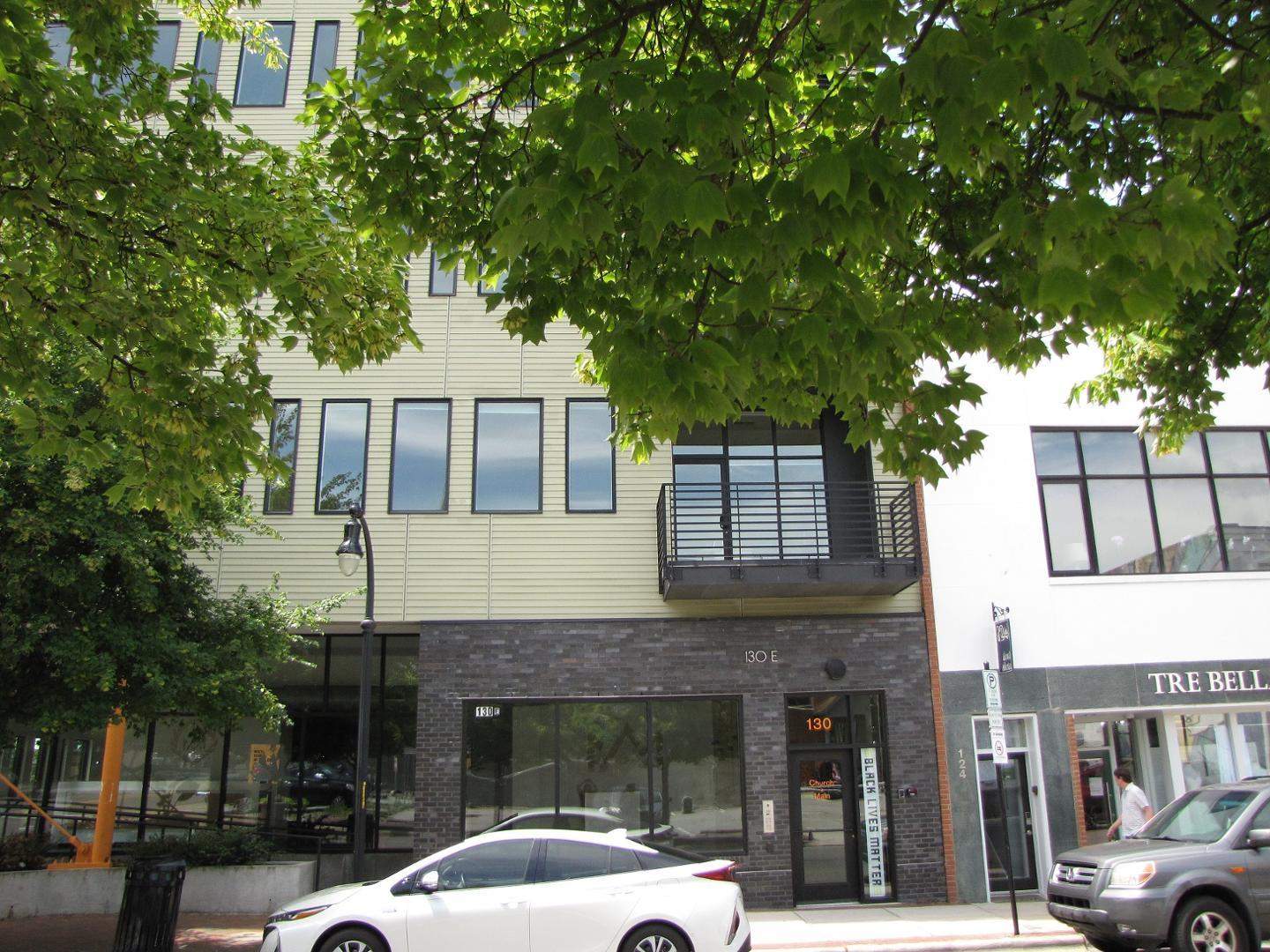 a couple of cars parked in front of a building