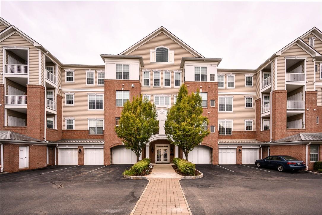 a front view of a residential apartment building with a yard