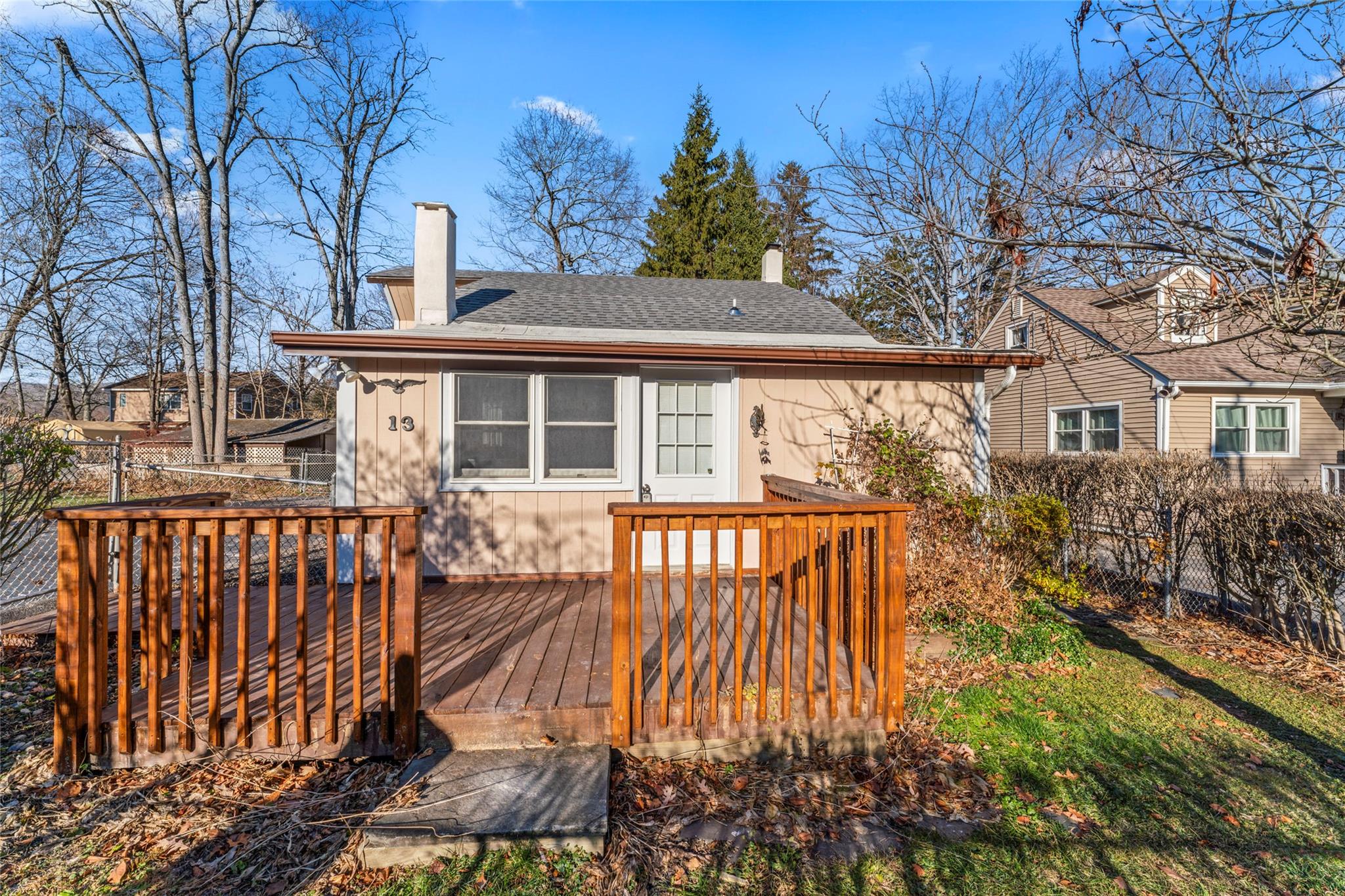 Rear view of house featuring a wooden deck