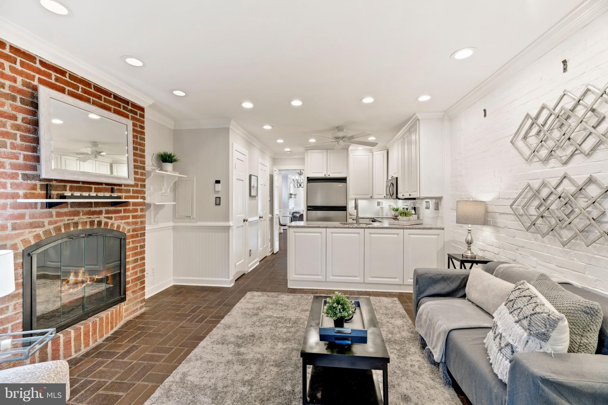 a living room with fireplace furniture and a fireplace