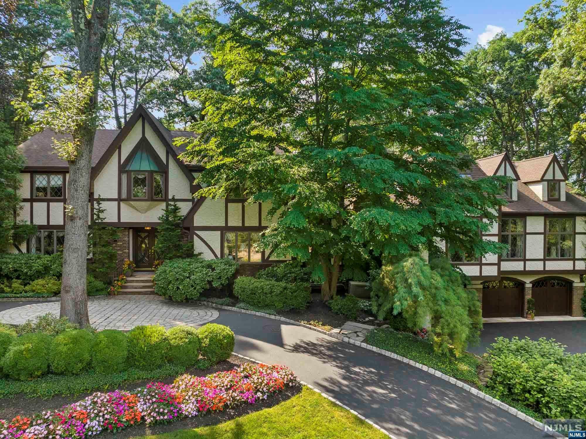 a front view of a house with a yard and a garden