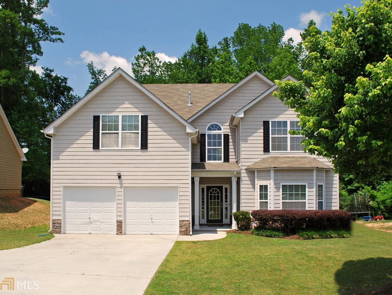 a view of house with yard and green space