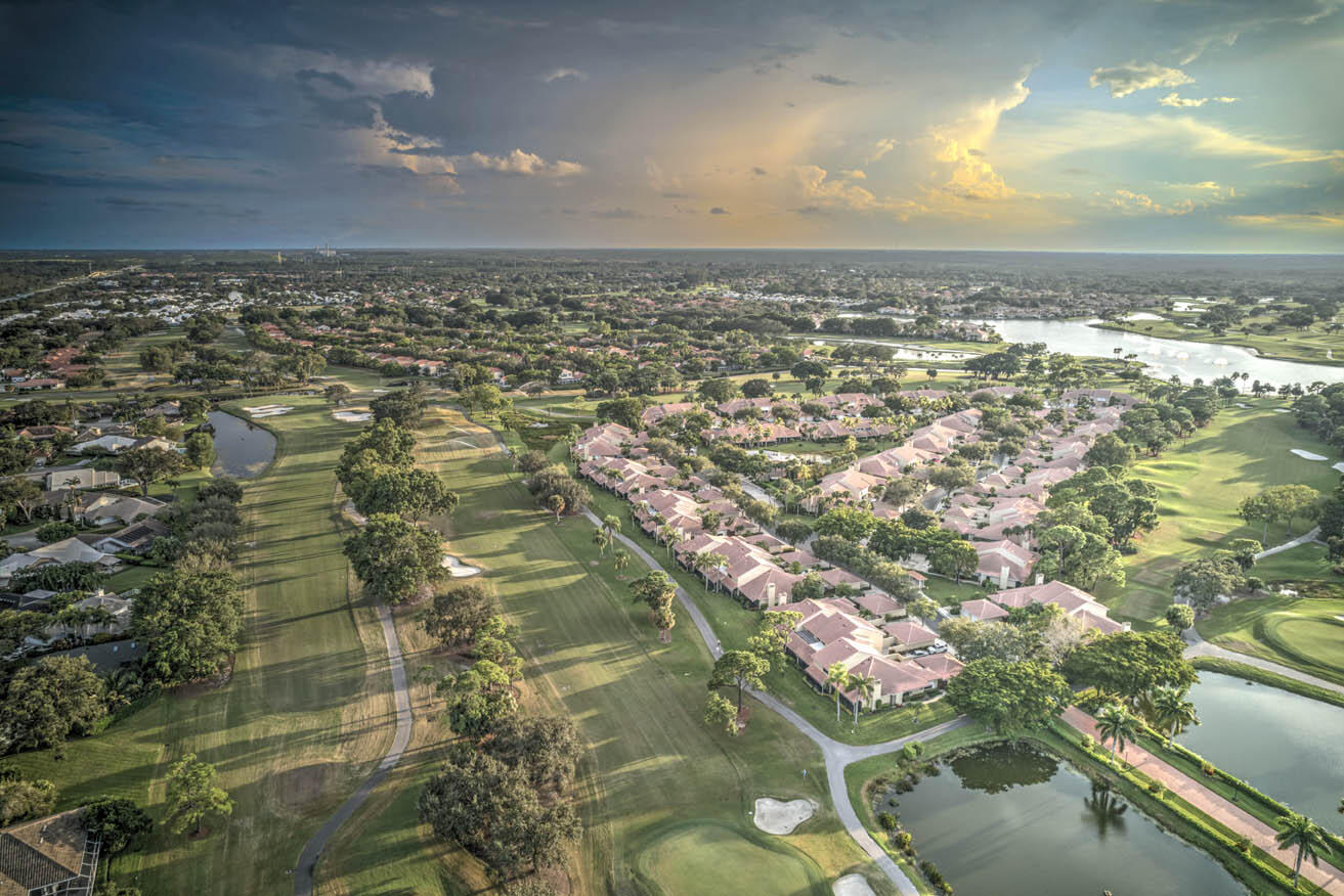 an aerial view of residential houses with yard