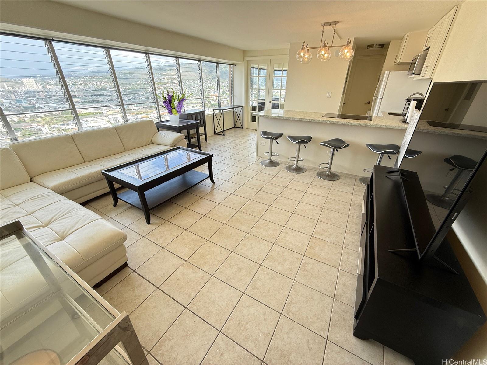 a living room with furniture and a floor to ceiling window