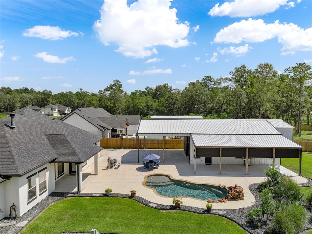 a aerial view of a house with swimming pool and furniture