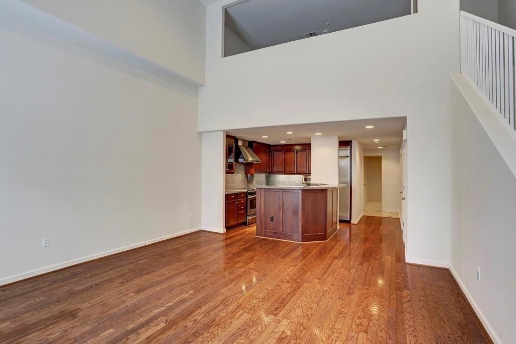 a view of a living room with wooden floor