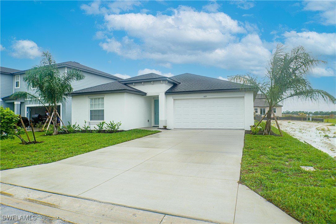 a front view of house with yard and green space