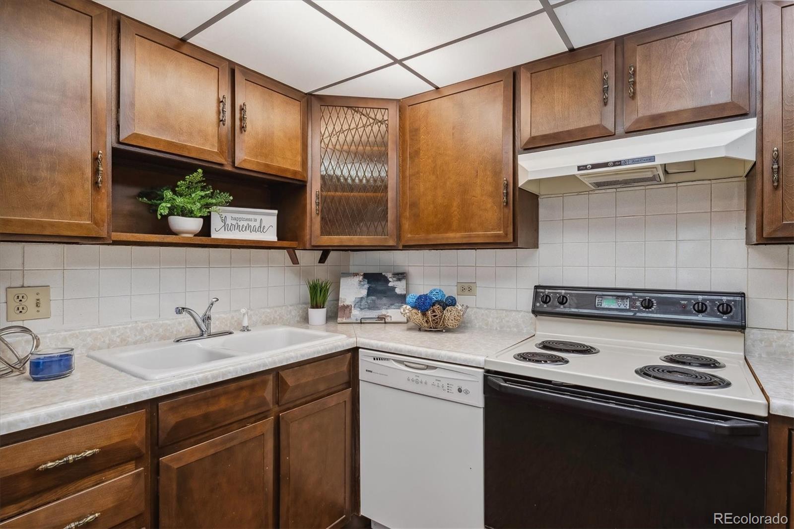 a kitchen with stainless steel appliances granite countertop a sink a stove and cabinets