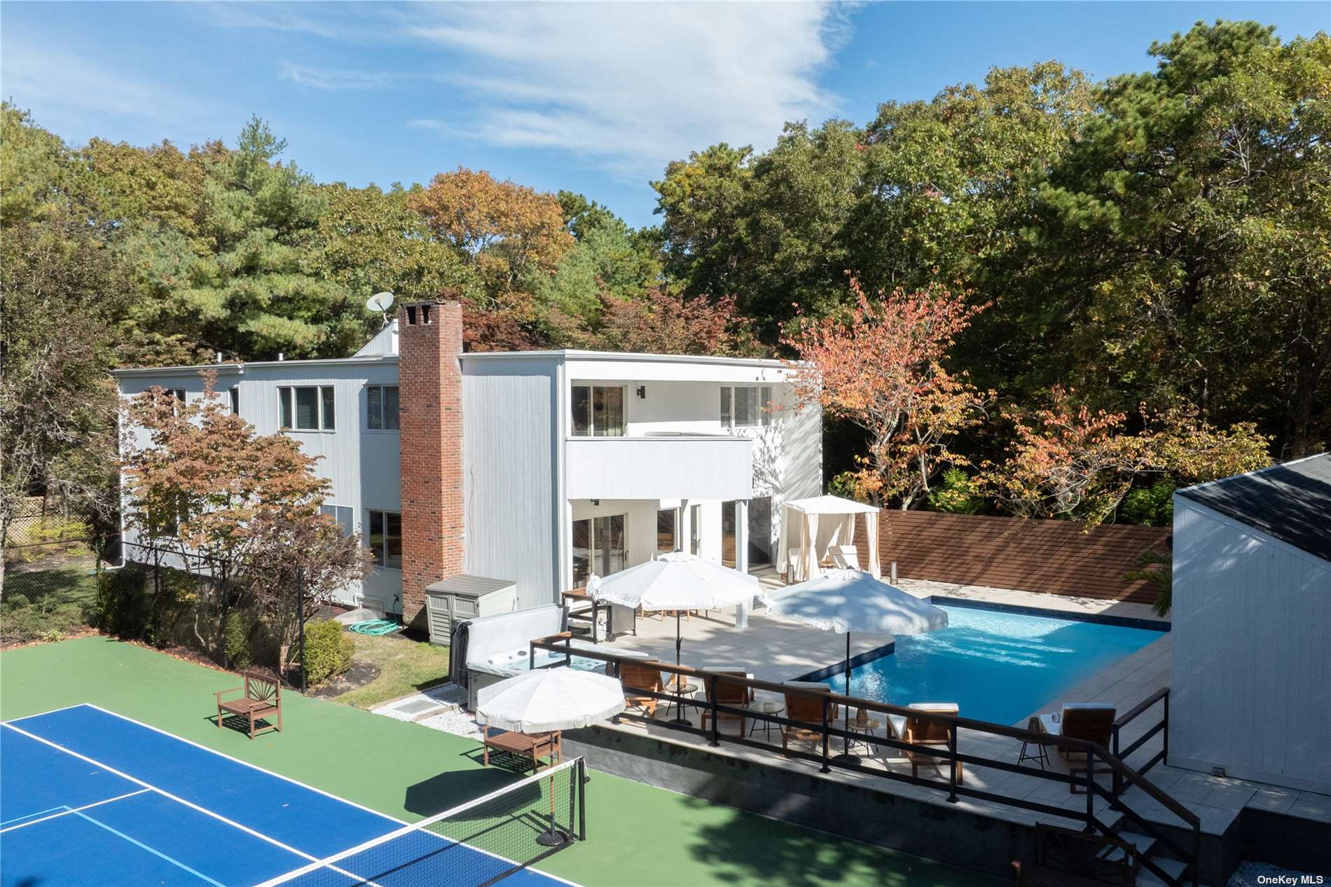 a view of house with swimming pool outdoor seating