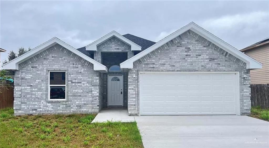 a front view of a house with garage