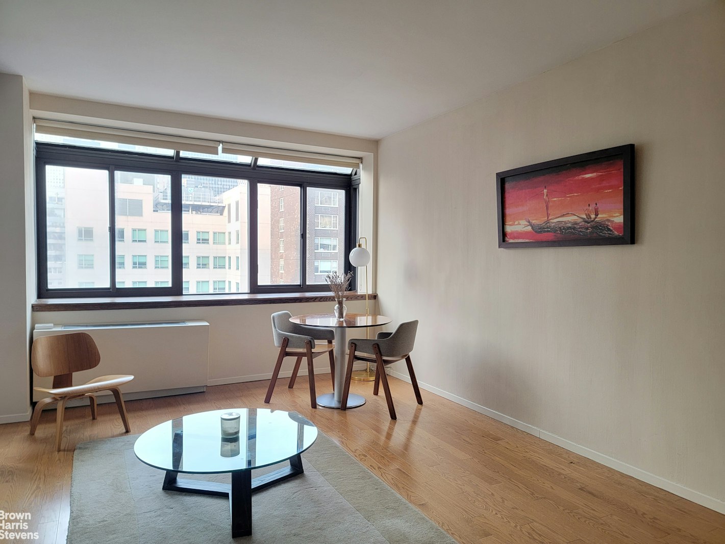 a living room with furniture a rug and a large window