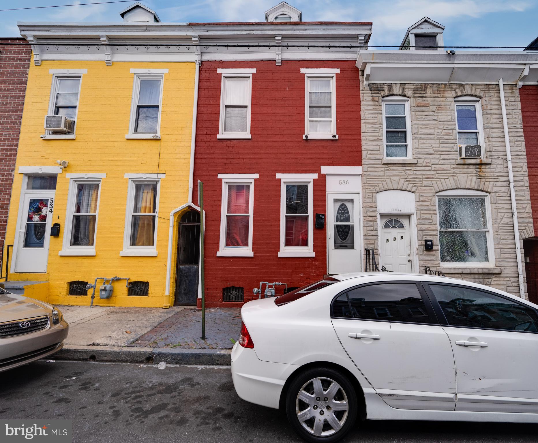 a front view of a house with a parking space