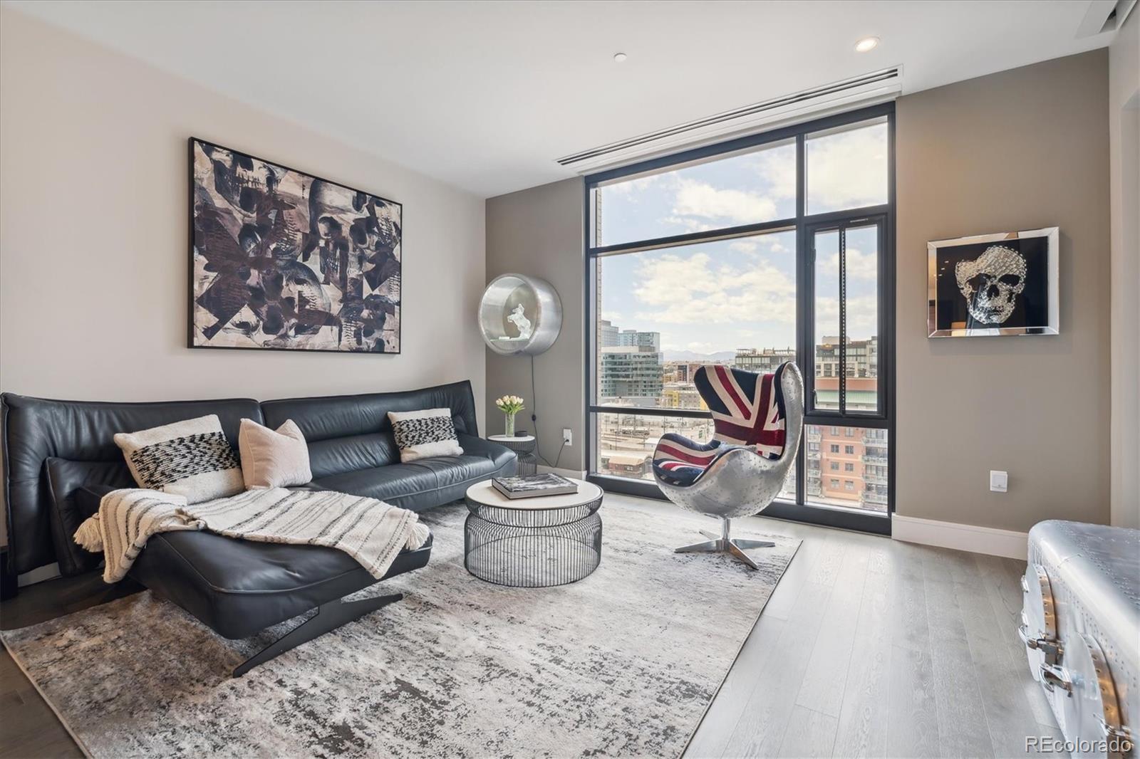 a living room with furniture and a floor to ceiling window