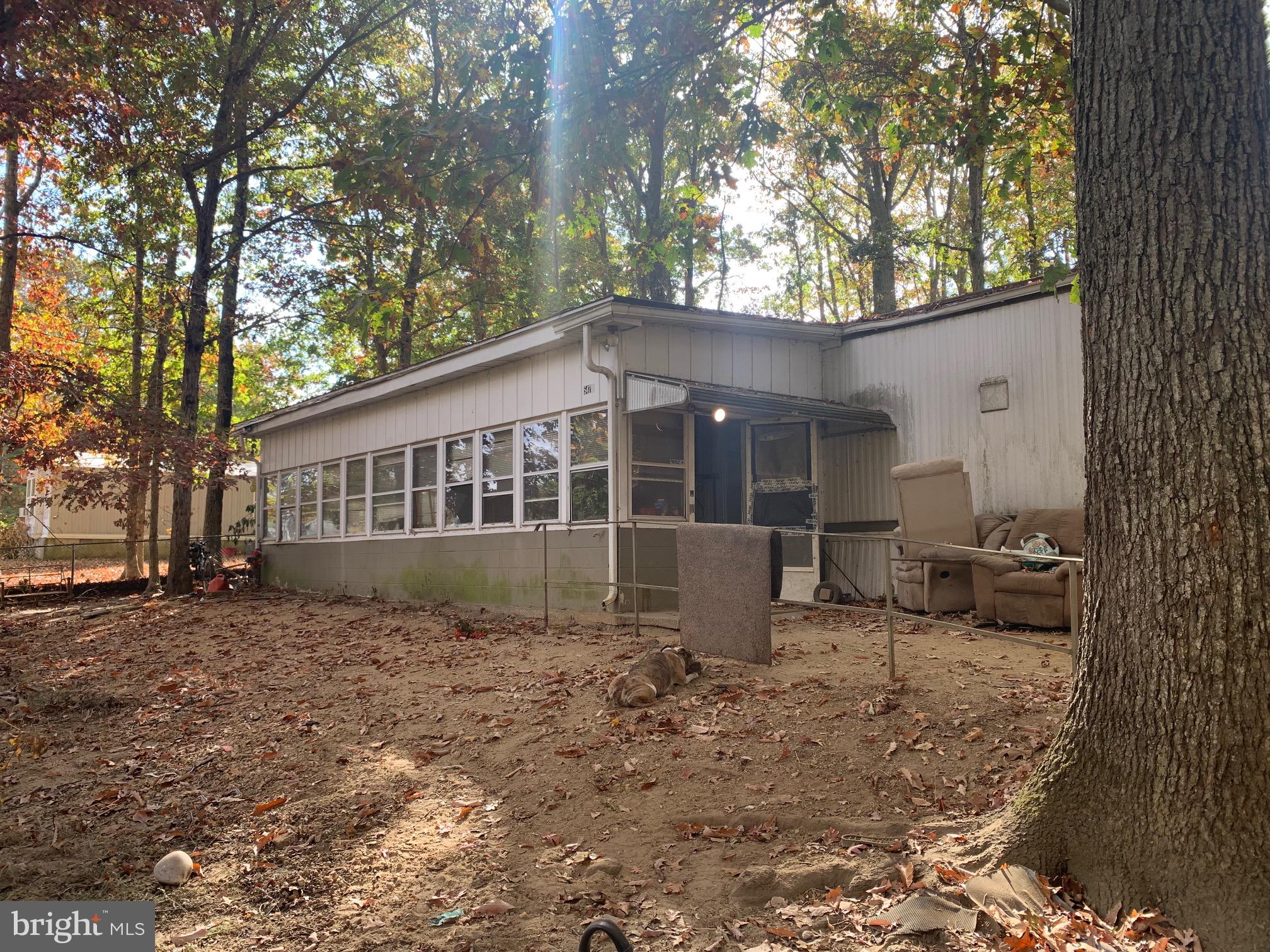 a view of a house with a yard and sitting area