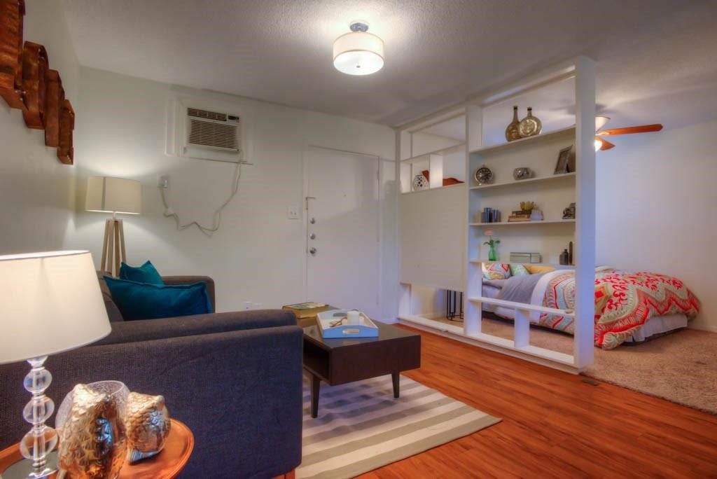 a living room with furniture and a wooden floor