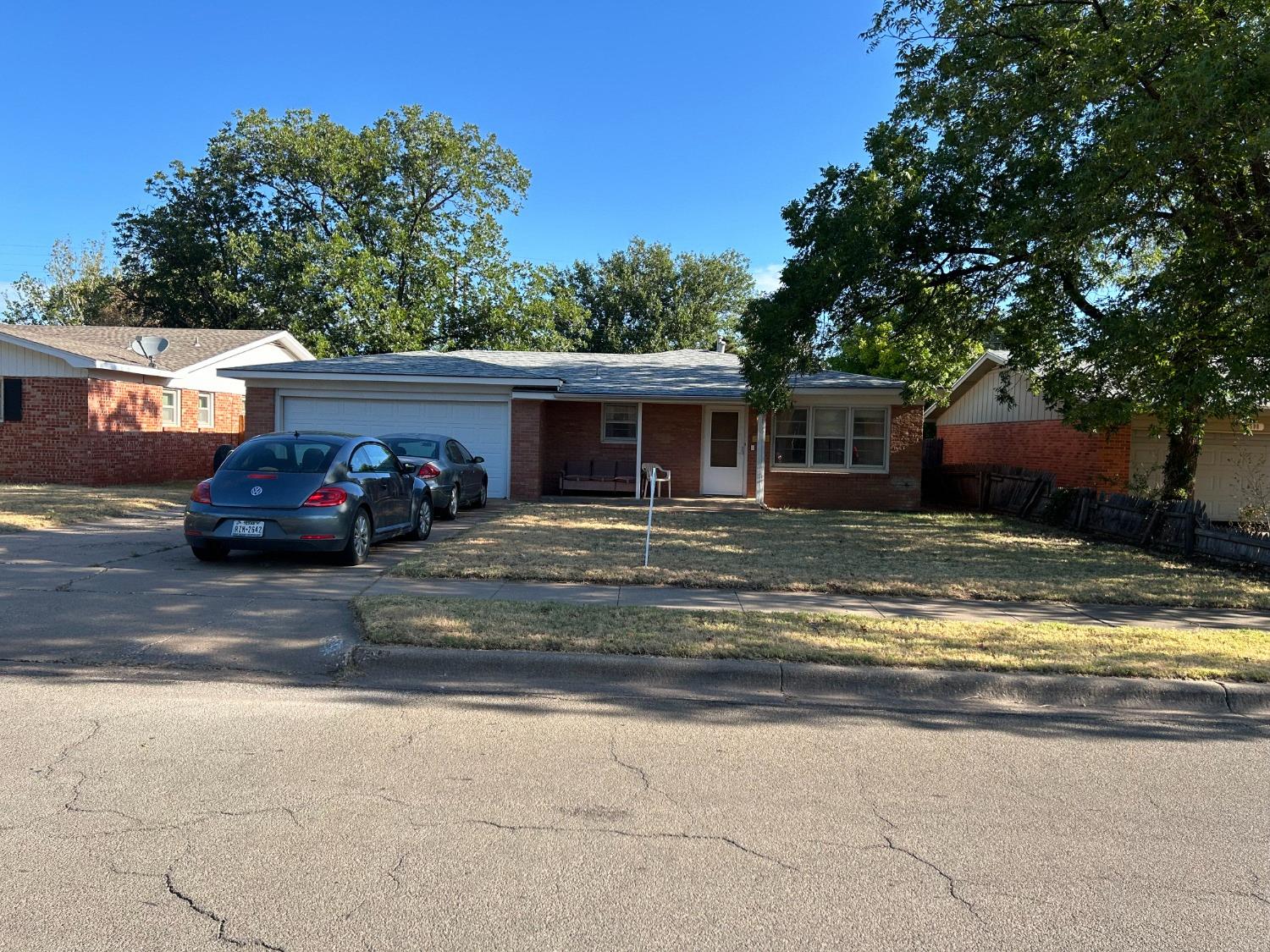 a view of a house with car parked beside it