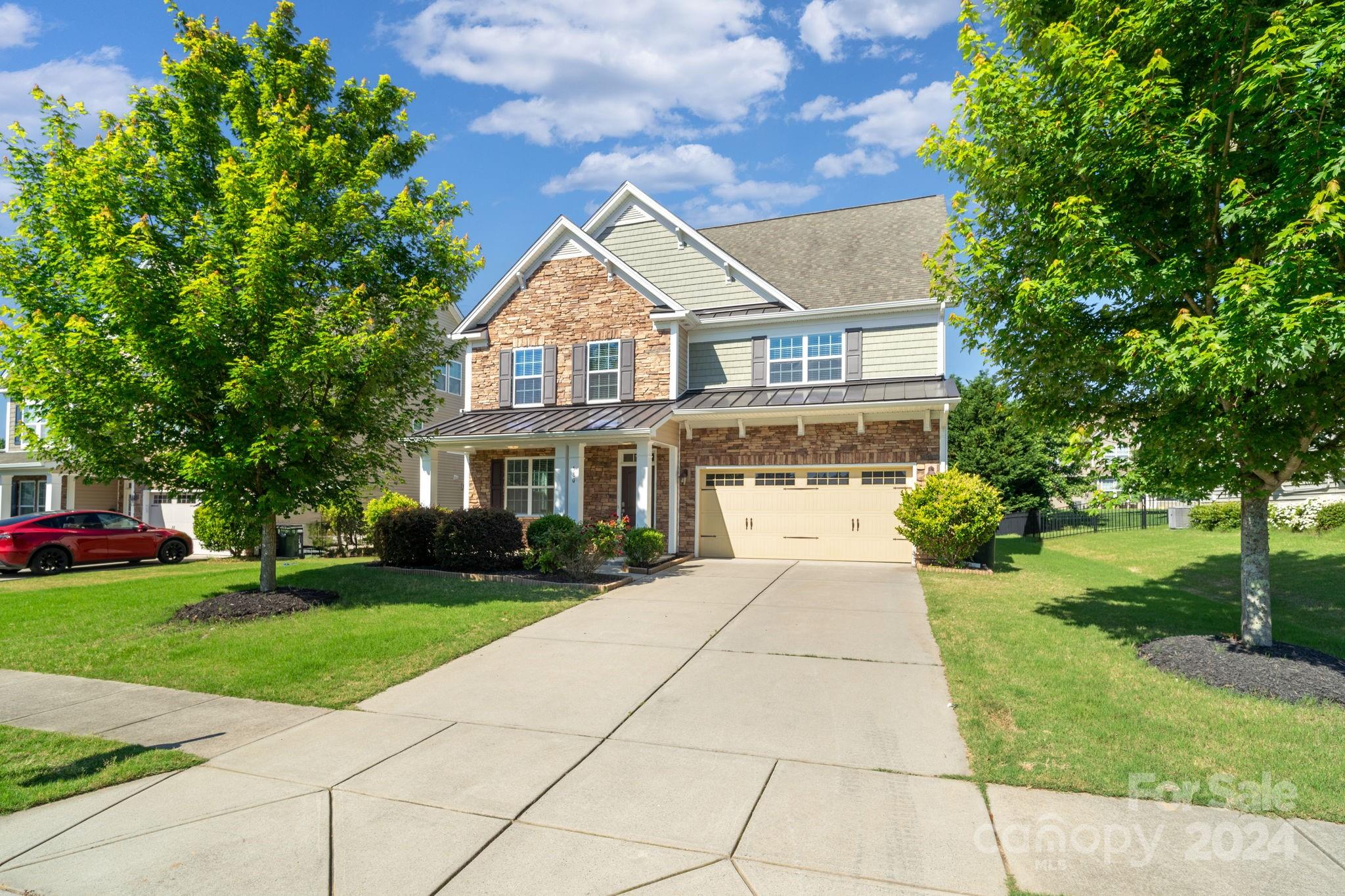 a front view of house with yard and green space