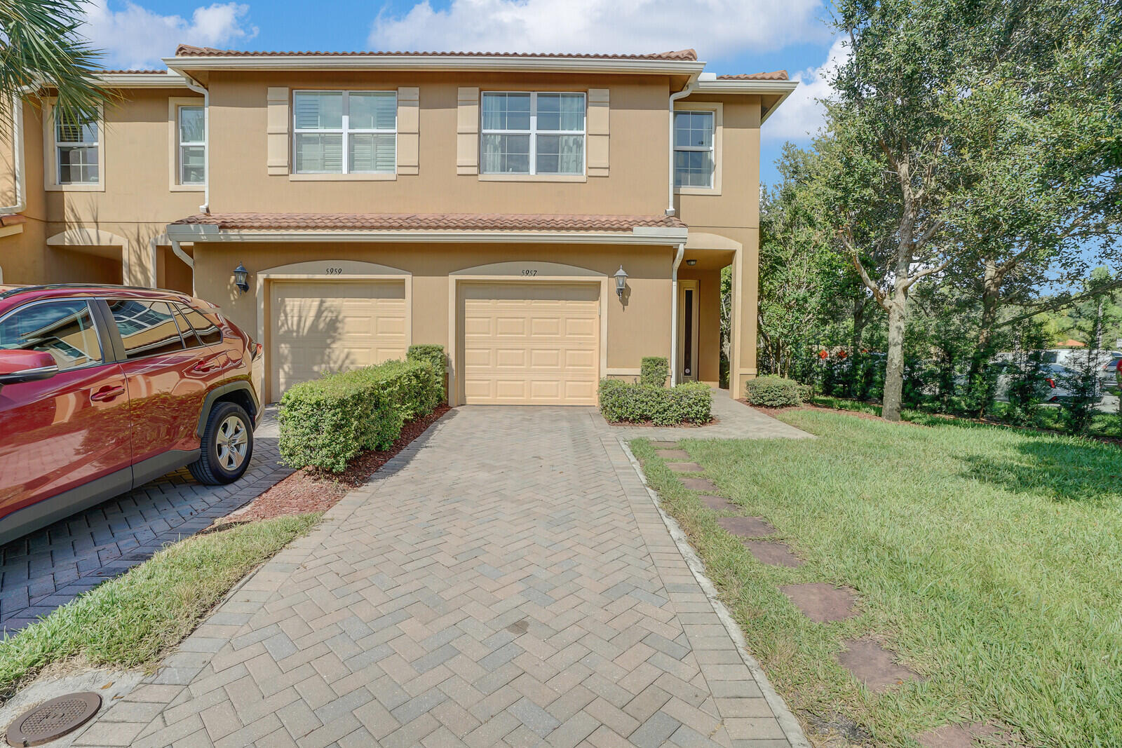 a front view of a house with a yard and garage