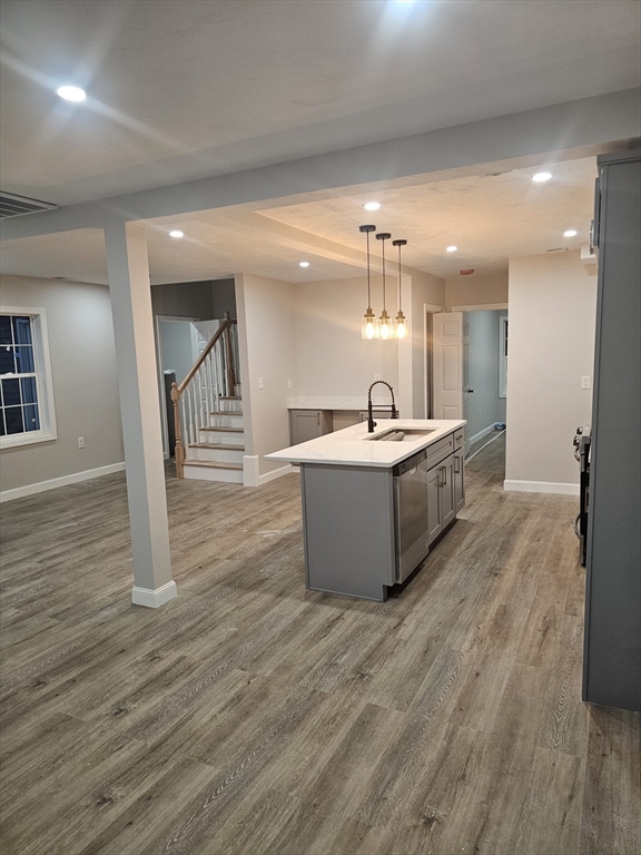 a room with gym equipment and wooden floor