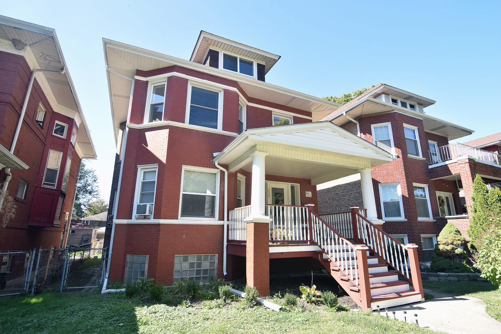 a front view of a residential apartment building with a yard