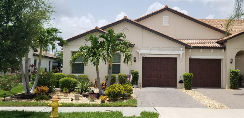 a front view of a house with a yard garage and outdoor seating