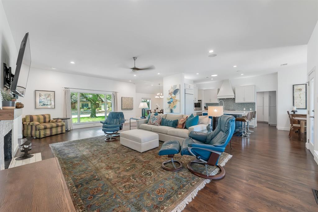 a living room with furniture wooden floor and a large window