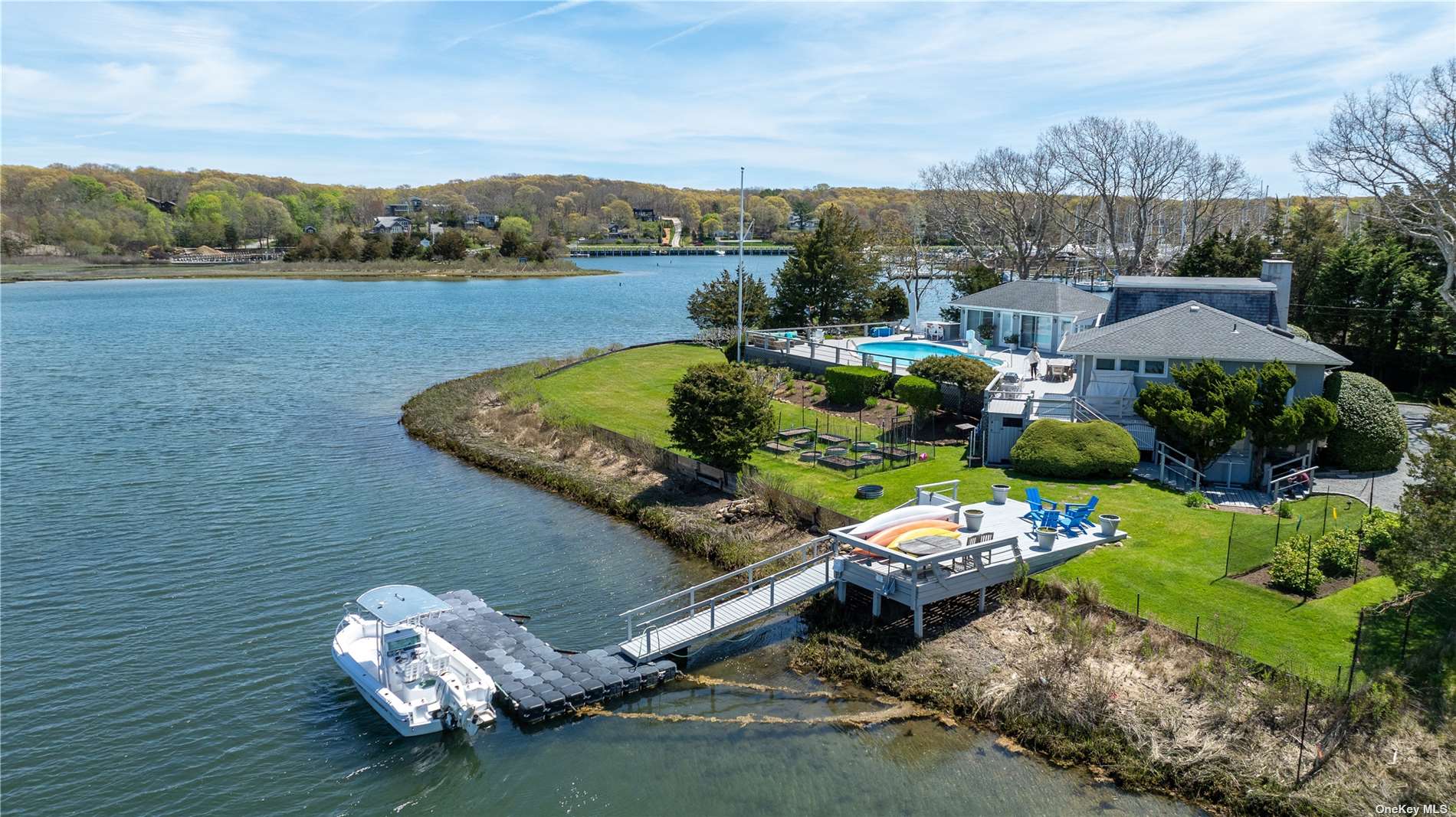 an aerial view of a house with a garden and lake view