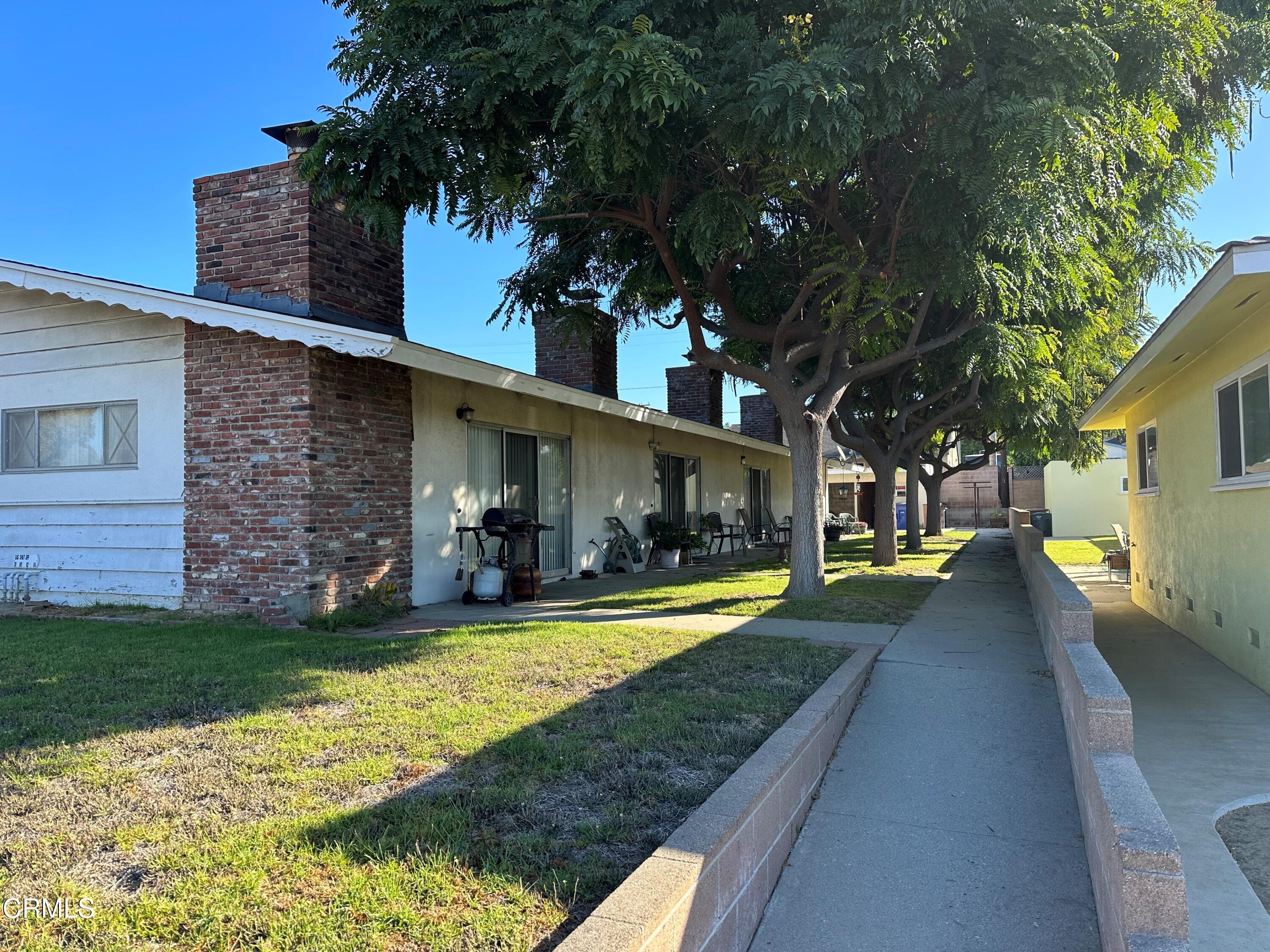 a view of a house with swimming pool and a yard