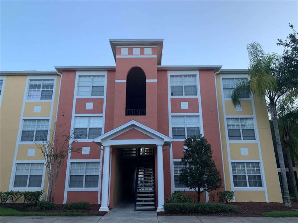 a front view of a residential apartment building with a yard