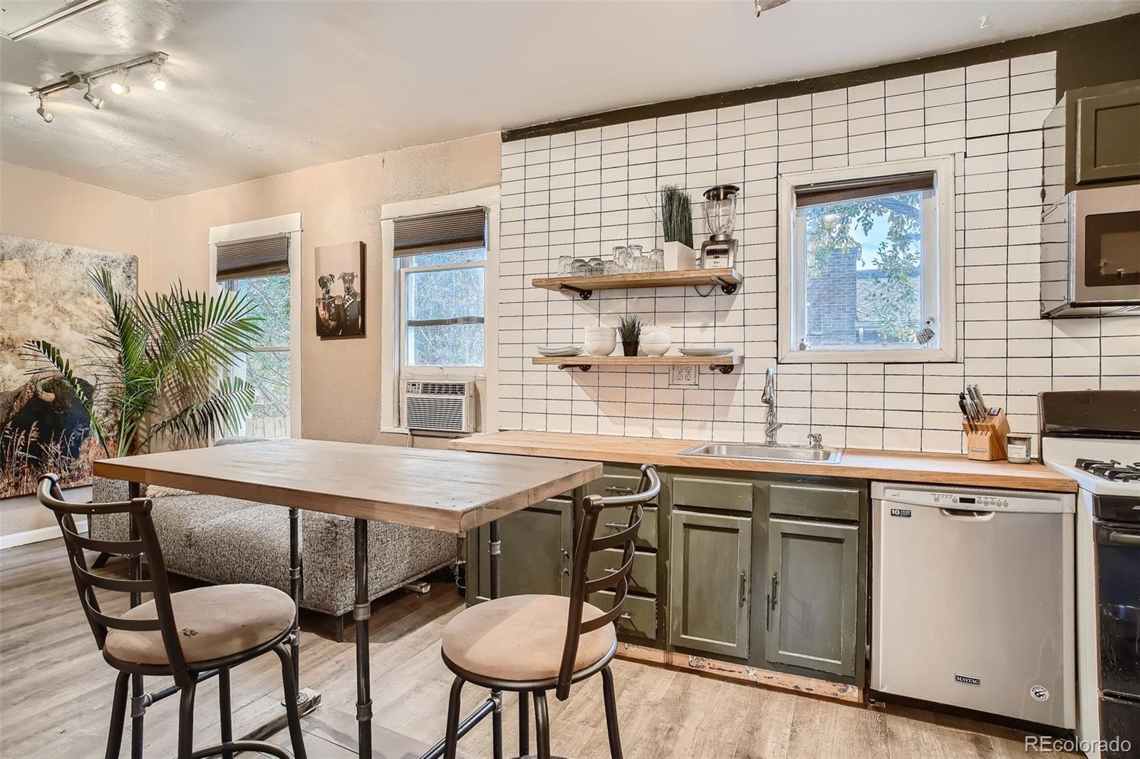 a kitchen with a table chairs sink and cabinets