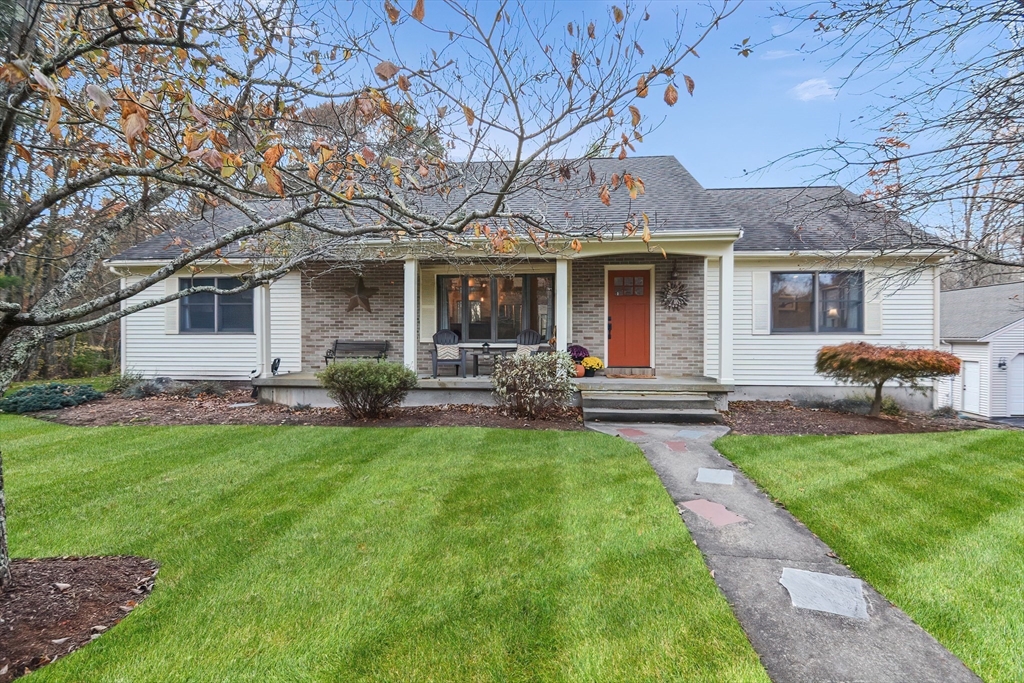 a front view of house with yard and outdoor seating