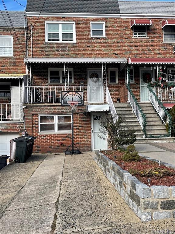 View of property featuring a balcony and a garage