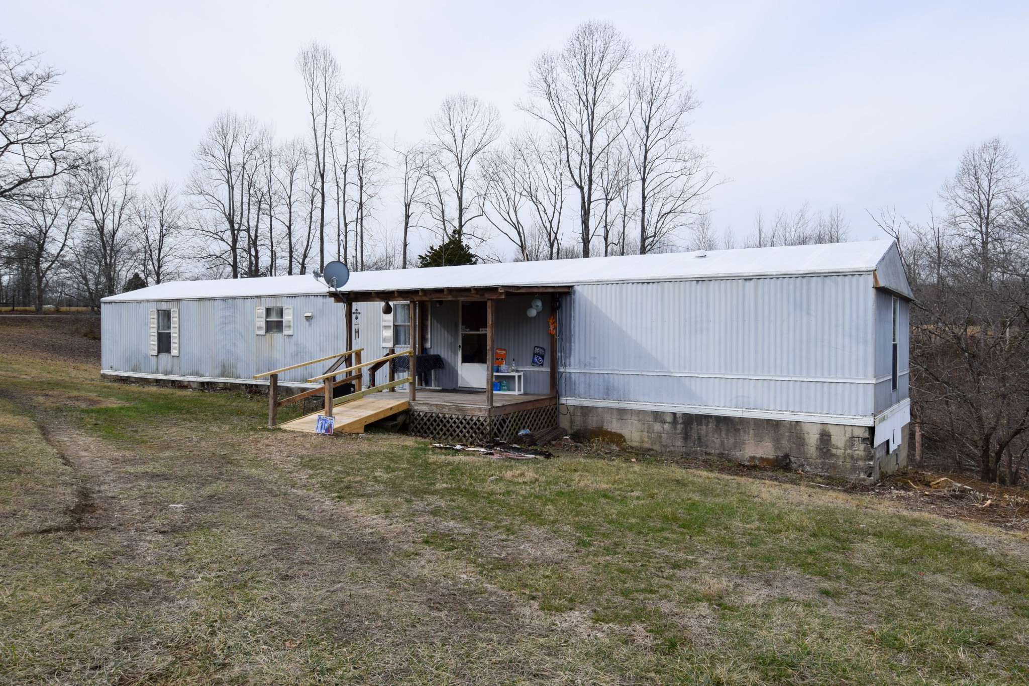 a view of a house with a yard and sitting area