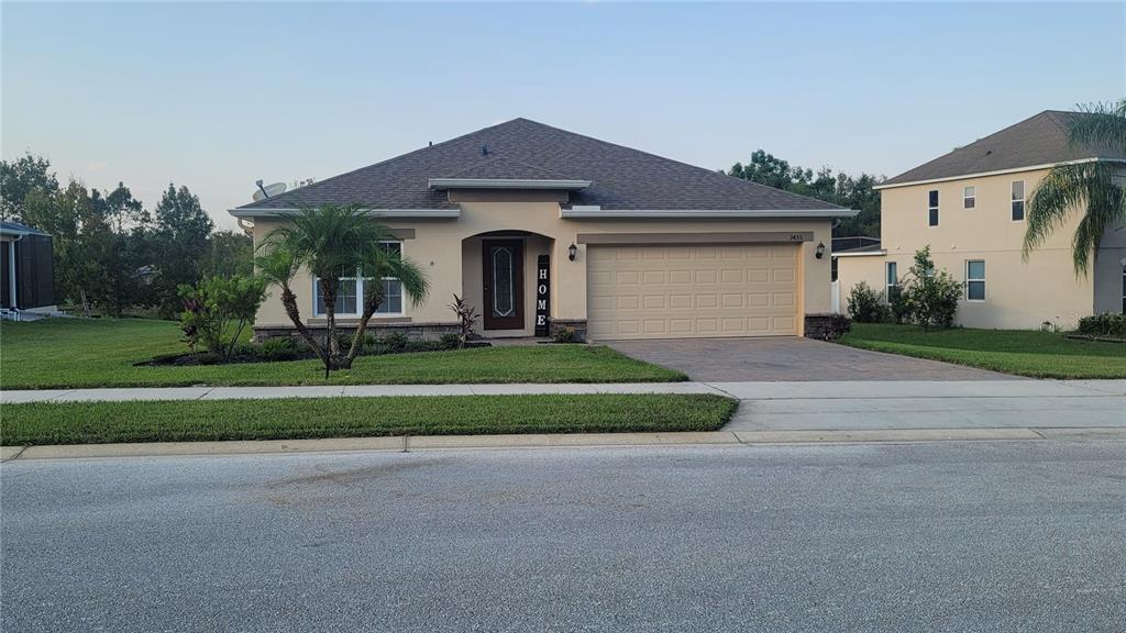 a front view of a house with a yard and garage