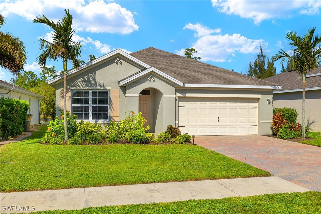 a front view of a house with a garden and plants