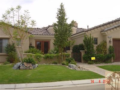 a view of a house with a yard and plants