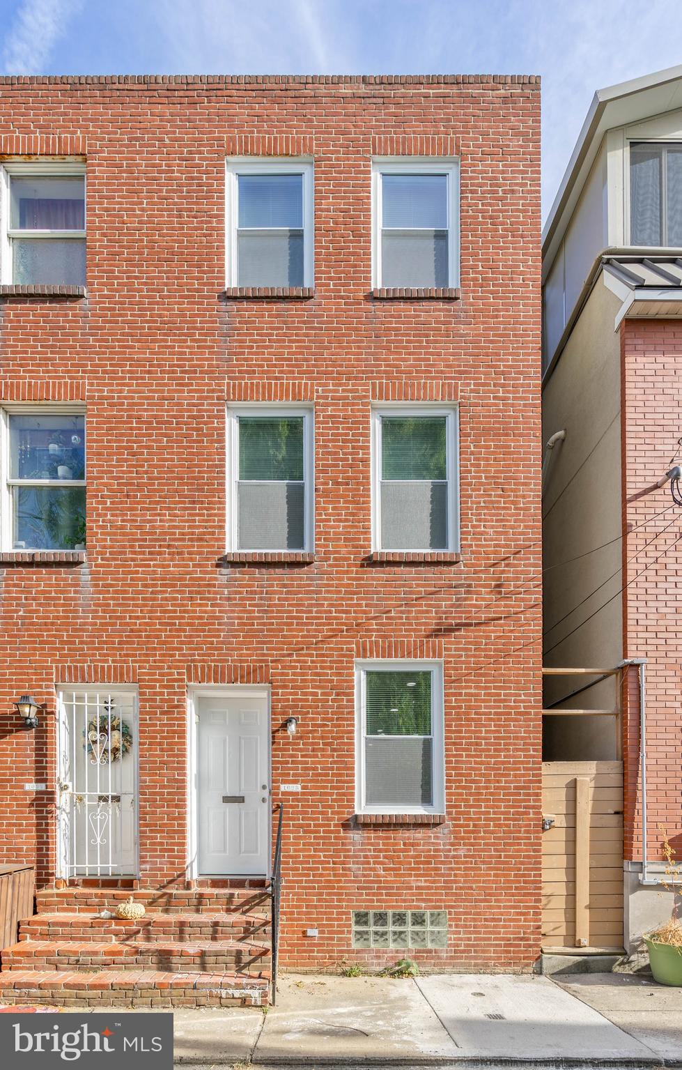 a red brick building that has lot of windows on it