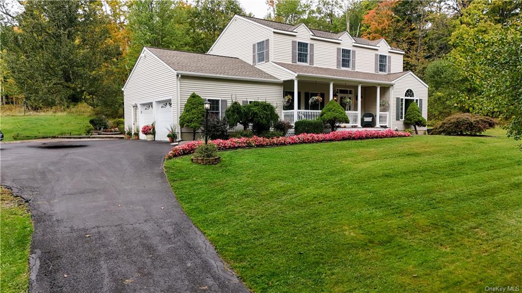 a view of a house with backyard sitting area and garden