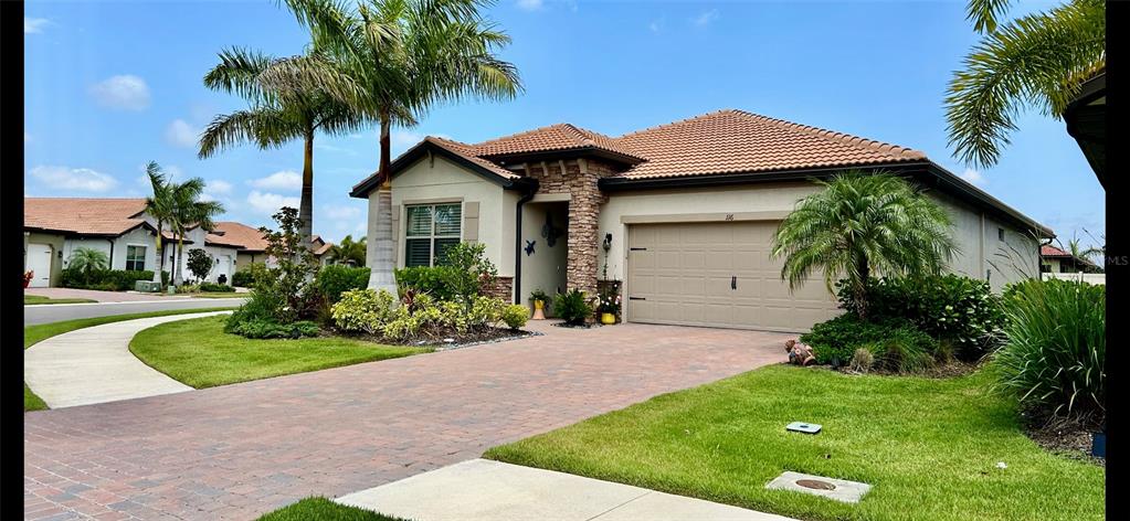 a front view of a house with a garden